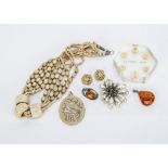 A French early 20th Century paste set and simulated pearl clip brooch, an amber silver set brooch