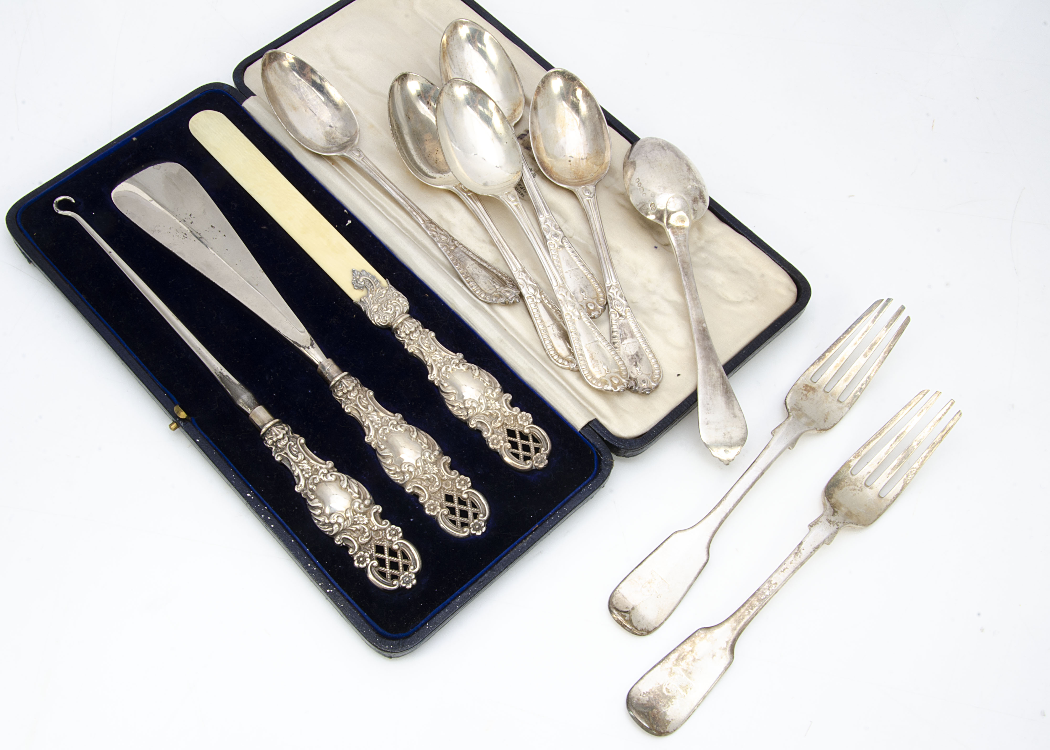 A set of six Victorian silver dessert spoons by George Adams, together with a pair of George Adams