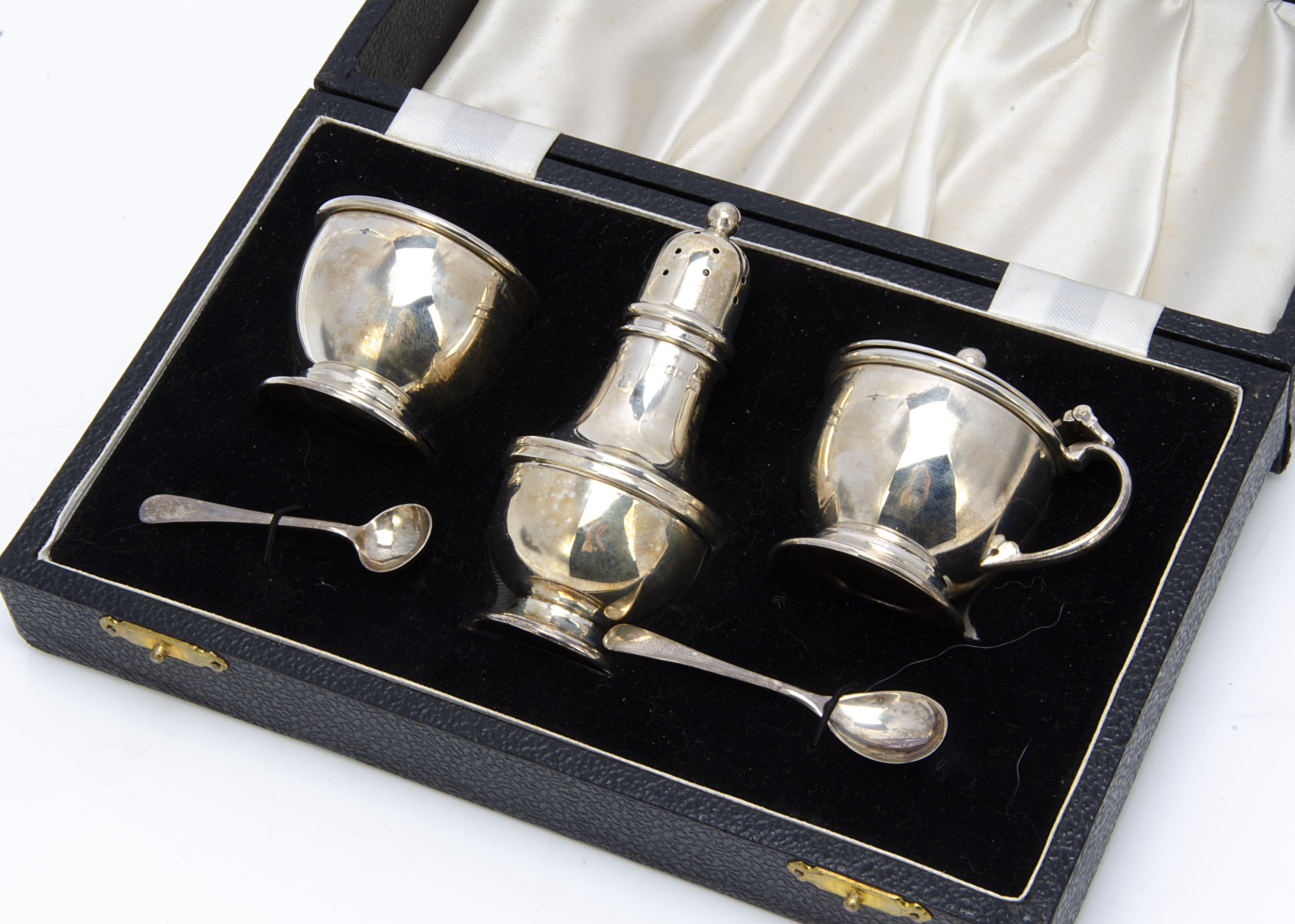 A 1960s three piece cruet set from CSG & Co, in fitted box with spoons