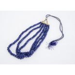 A continental three strand rough polished sapphire necklace, 52cm including silk cord, 979ct