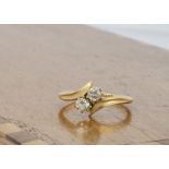 An 18ct gold diamond crossover dress ring, the old cut diamonds in claw settings, on a yellow