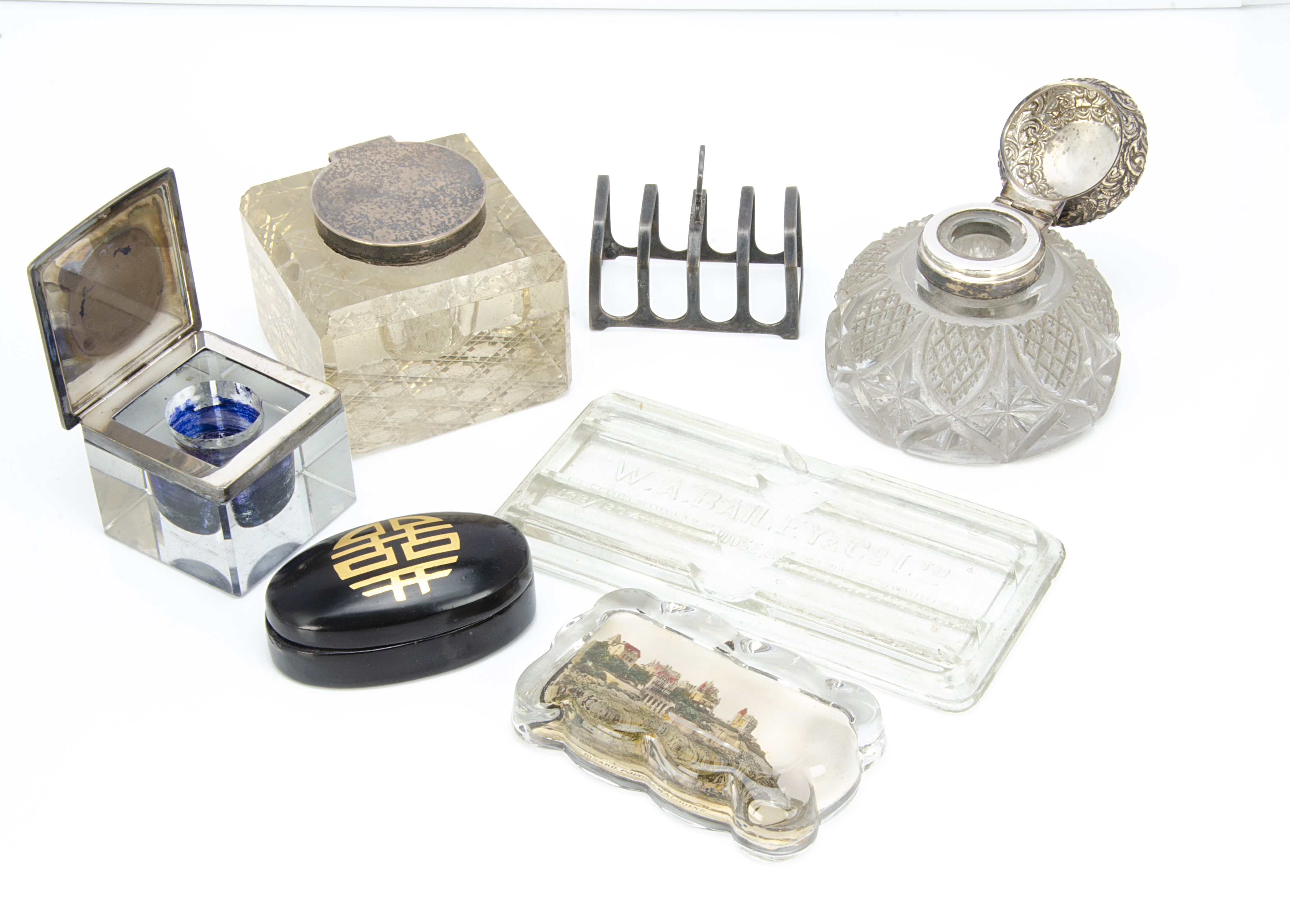 Three Victorian and early 20th Century glass and silver ink wells, together with a small silver