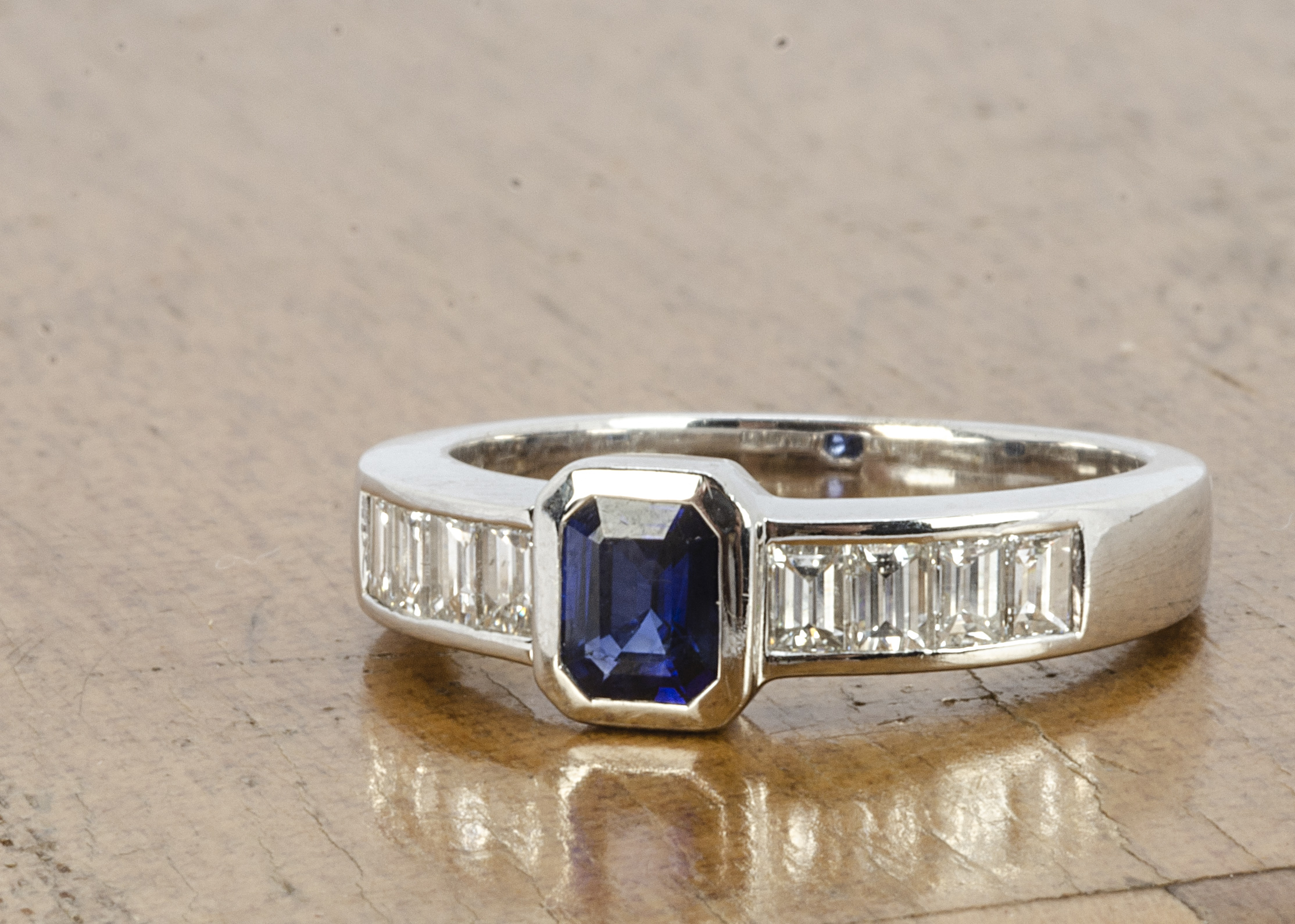An 18ct white gold Art Deco style sapphire and diamond dress ring, the rectangular cut sapphire