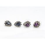 Two pairs of silver pear shaped stud earrings, one set with sapphires, the other set with rubies