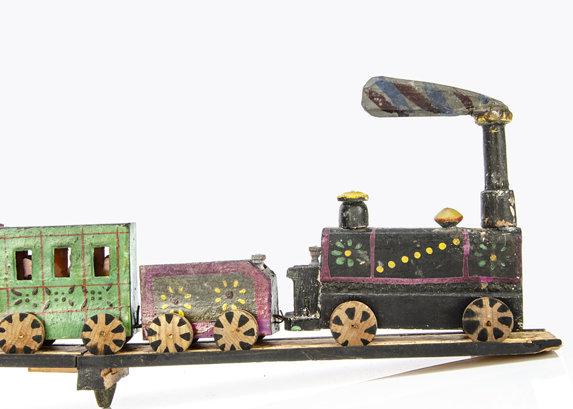 A rare Erzgebirge mid 19th Century painted wooden train, a black painted engine with large chimney - Image 2 of 3