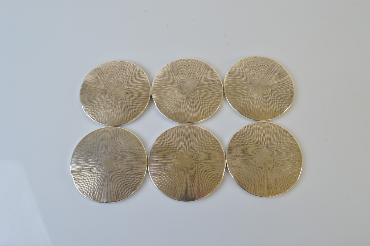 A set of six contemporary silver coasters, having engine turned design. Birmingham, 1973. 8.2cm