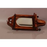 An Edwardian rosewood and inlaid wall mirror, 54cm, with shelf bracket and broken pediment