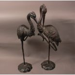 A pair of second half 20th century bronze figures of cranes, tallest 95cm, the shorter with