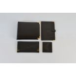 A collection of black leather wallets, and other items including a carry photo case, and notebook,