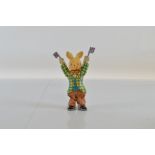 A Nomura Toys tinplate cheering rabbit, holding Union Jack flags aloft , with key in back. 18cm