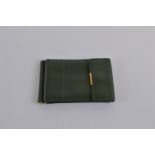 A green leather Rolex card and money wallet, of rectangular form with gilt metal fittings. 11.5cm
