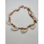 A Matisse designed costume necklace, with white textured enamel of wave design and adjustable clasp,