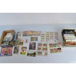 A mixed lot of ephemera, including early 20th century postcards, cigarette cards, cigar rings,
