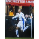 JERMAINE BECKFORD AUTOGRAPH A 16 x 12 col photo of the Leeds striker running away in celebration