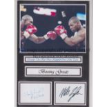 MIKE TYSON / EVANDER HOLYFIELD AUTOGRAPHS A laminated mount with an action picture at the top and