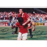 MAN UNITED Autographed 12 x 8 col photo of Steve Coppell leaping upon team mate Stuart Pearson who