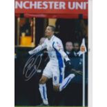 JERMAINE BECKFORD Autographed 12 x 8 col photo of the Leeds United striker running away in