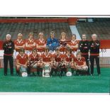MAN UNITED Autographed 12 x 8 col photo of the 1977 FA Cup winners posing with their trophy during a
