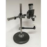 A Chrome and painted metal binocular microscope. C