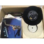 A box of 7 inch singles and EPs by various artists