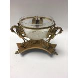 A glass sugar bowl inset into a gilt Classical stand . Together with a pair of gilt wine coasters