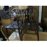 A set of four Ercol cottage style dining chairs with shaped backs and solid seats (4)