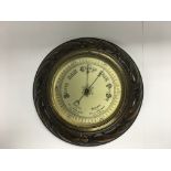 A carved mahogany circular wall barometer. NO RESE