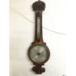 A Victorian oak barometer by Reynolds & Wiggins of