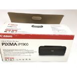 A Canon pix a ip1900 printer boxed. With instructi