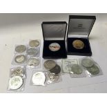 A collection of silver 1oz dollars and other coins