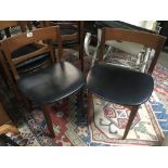 A set of modern teak dining chairs maker Nathan with black covered seats. (6)