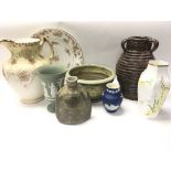 A collection of ceramic vases including a wedge wo