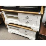 Two modern white and light oak low tables With open shelves flanked by drawers. (2)