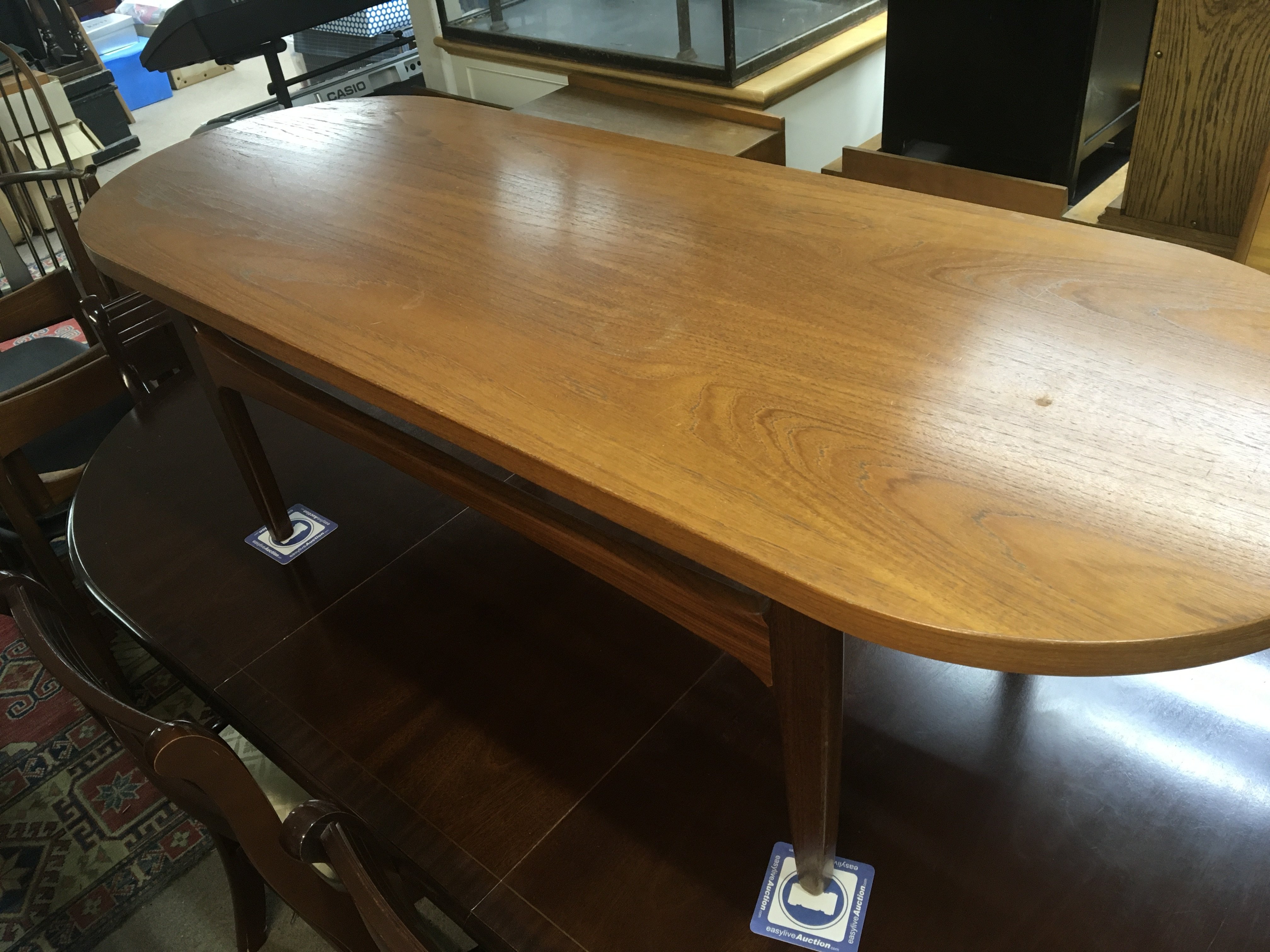 A modern design teak two tone coffee table possible G-Plan with an oval top on square legs. Length