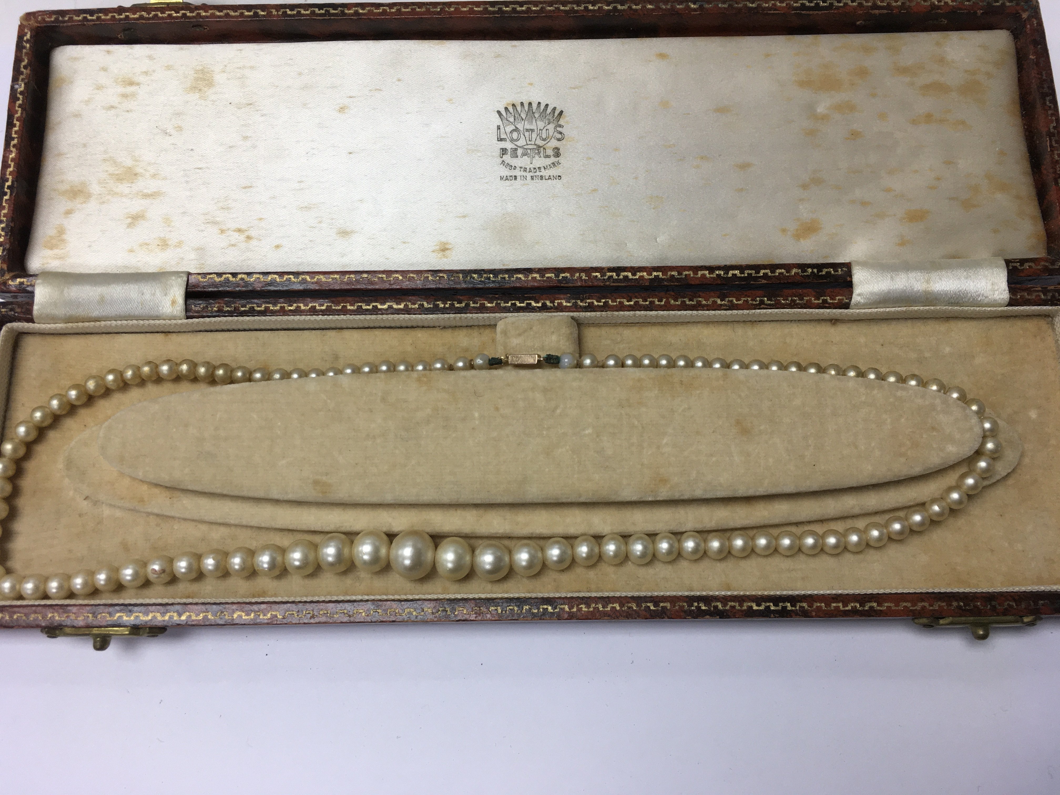 A cased Pearl necklace with 9 ct gold clasp .