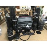 A Nikon FE camera plus a collection of camera lens
