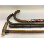 Four walking sticks including a horn handled examp
