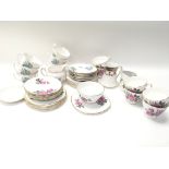 2 tea sets decorated with flowers and foliage. roy