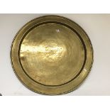 A arts and craft brass platter and a Indian brass