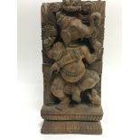 A carved wooden panel depicting Ganesha, approx 14