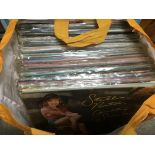 Three bags containing a large collection of country music LPs.