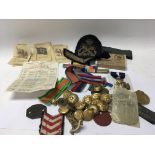 A collection of military medals badges and buttons