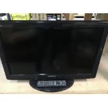 A Panasonic 26 inch TV and remote together with a