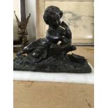 A bronze figure in the form of a reclining child reading - NO RESERVE