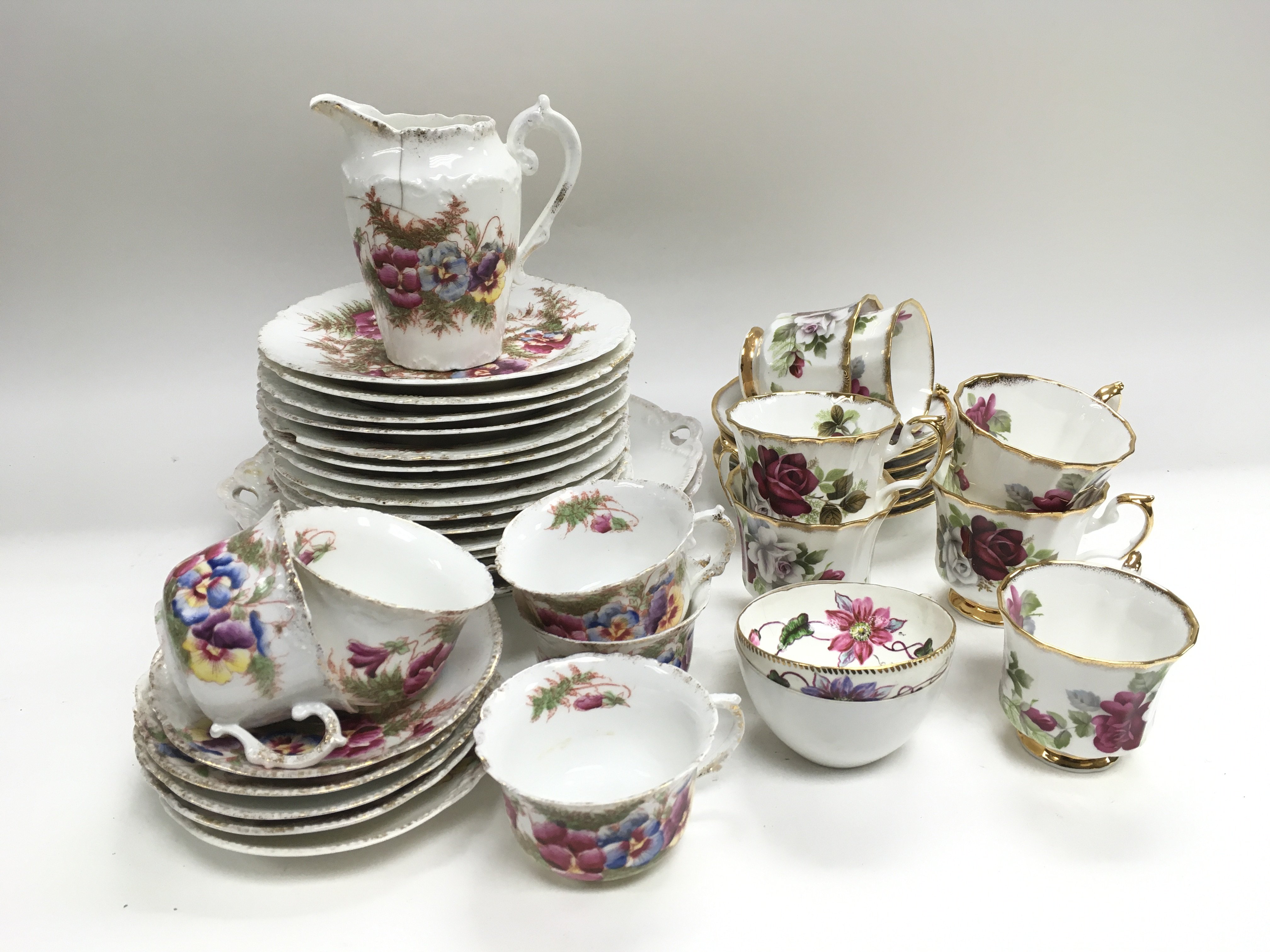 Two decorative china tea sets decorated with flowe