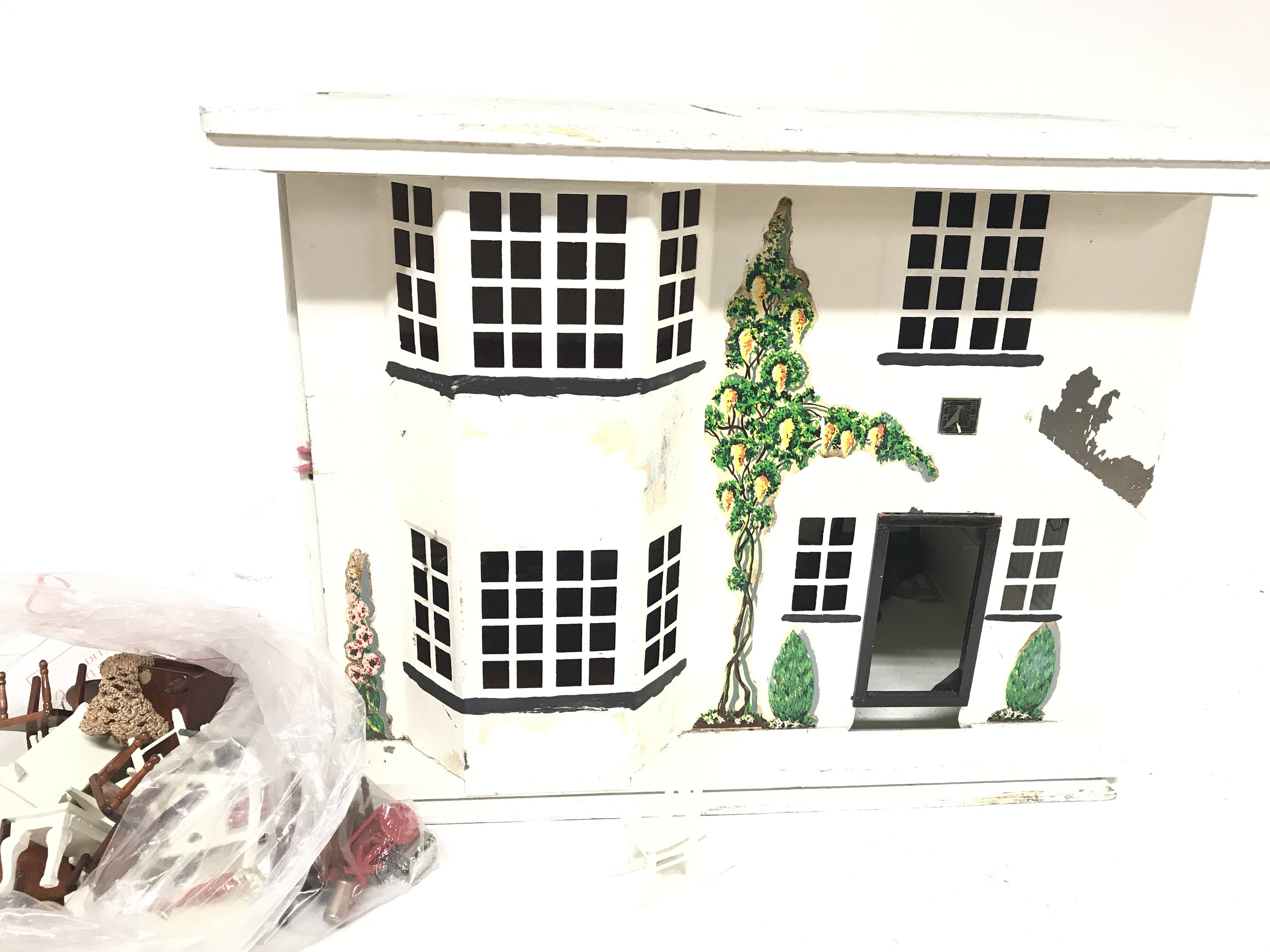 A dolls house with a sliding front and accessories