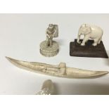 A collection of small carved ivory and bone figures and a mother of pearl carving in the form of a