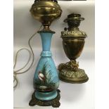 Two Victorian oil lamps comprising a painted examp