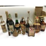 A collection of bottled spirits including Dimple H