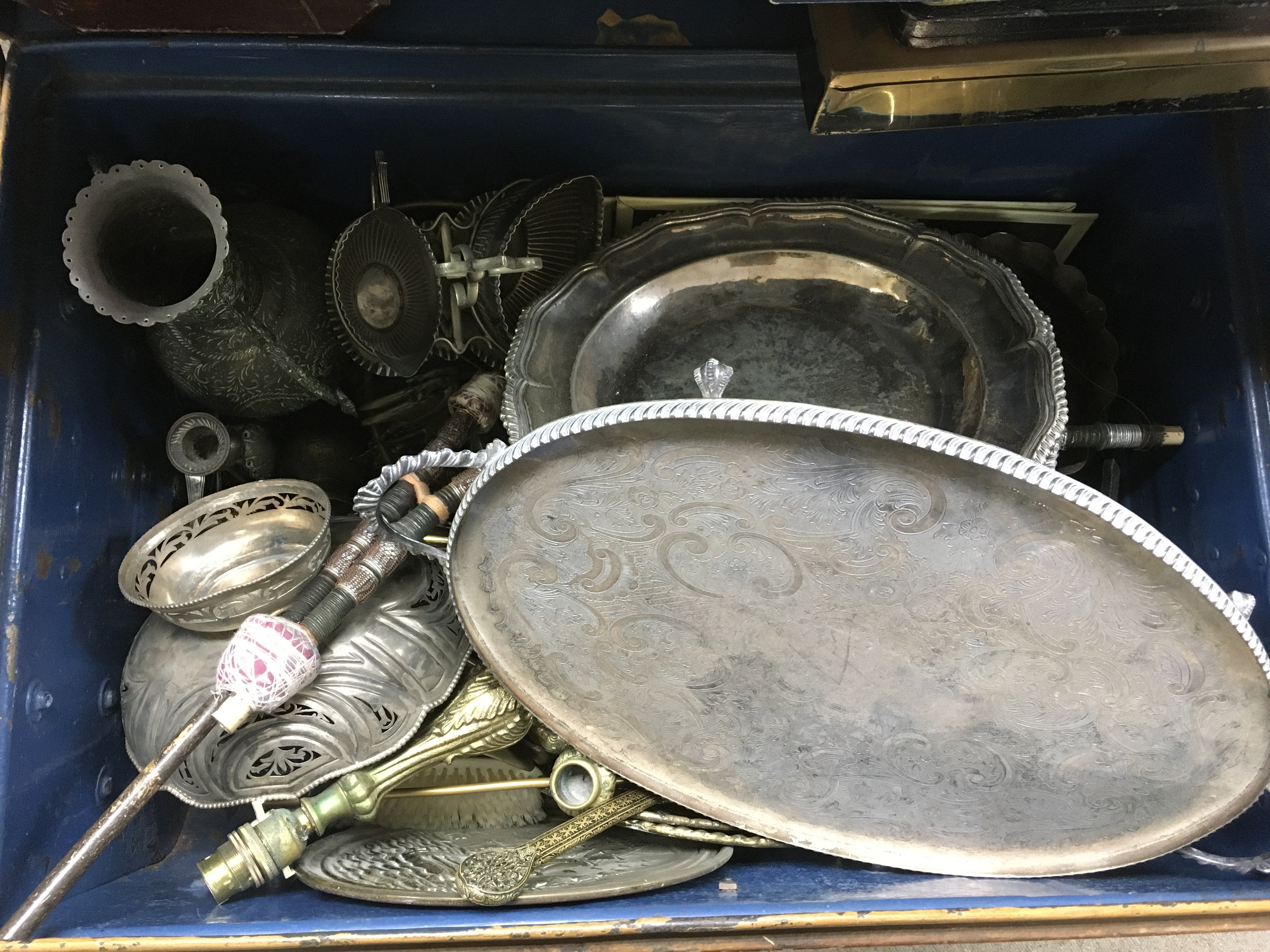 A tin trunk and metal ware contents.